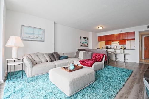 a living room with two couches and a kitchen at Upscale Apartment in the Heart of Brickell in Miami