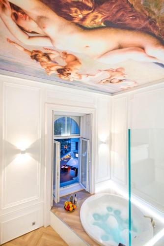 a bathroom with a bath tub and a painting on the ceiling at TOP Luxury Suites in Budapest