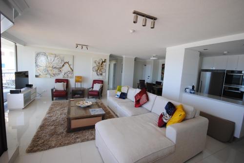 a living room with a couch and a table at Albatross North Apartments in Gold Coast