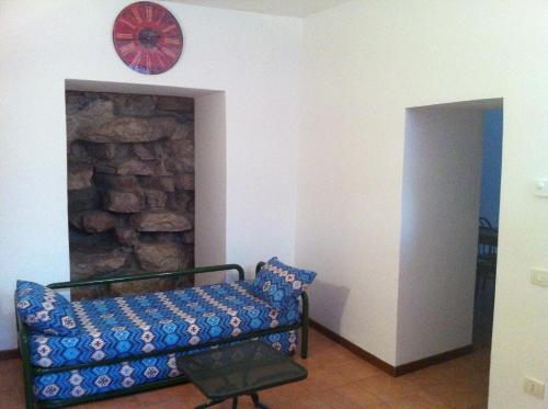 a living room with a couch and a clock on the wall at Monte Cavallo in Assisi