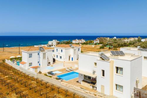 an aerial view of a house with the ocean in the background at Villa Diana Seaside in Pomos