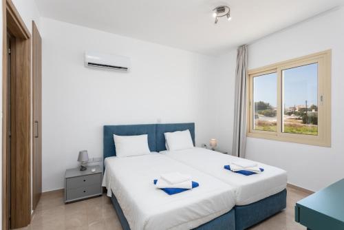 a bedroom with a large bed and a window at Villa Diana Seaside in Pomos