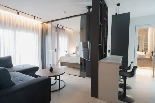 uma sala de estar com um sofá e um quarto com uma cama em ID Residences 201 em Volos