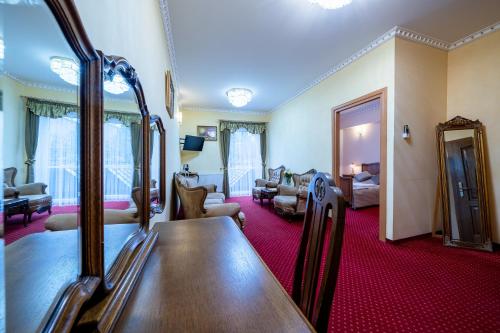 a living room with a room with a room at Piastun SPA&Wellness Krynica-Zdrój in Krynica Zdrój