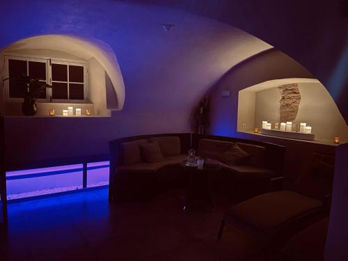 a dark living room with a couch and a table at Saku Manor & Beerspa in Saku