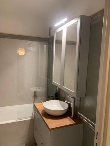 La salle de bains est pourvue d'un lavabo blanc et d'une baignoire. dans l'établissement Residence des Coteaux du Preconil, à Sainte-Maxime