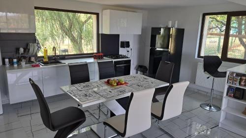 a kitchen with a table and chairs in a kitchen at Casa 3 Catei Veseli in Seciu