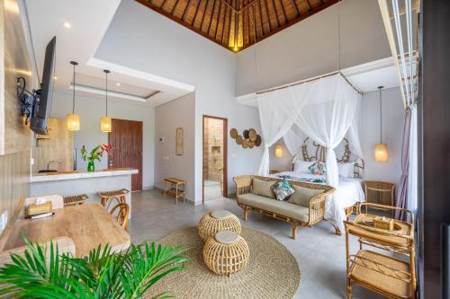 a bedroom with a bed and a living room at Kulta Villa Bali in Munggu
