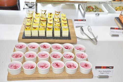 a table with a cake and some cupcakes at Courtyard by Marriott Ahmedabad in Ahmedabad