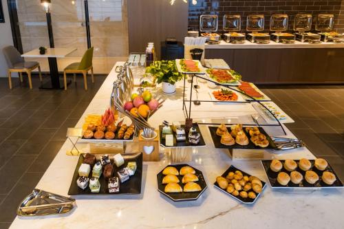 a buffet with many different types of food on a table at Atour Hotel Weifang Jinma Road City Hall in Weifang