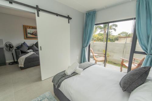 a bedroom with a bed and a large window at Cozy Apartment Near The Airport in Hallack Rock