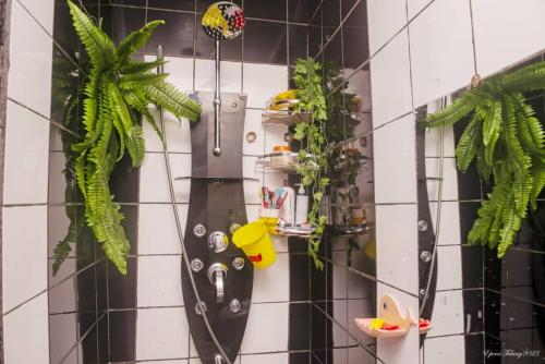 a kitchen with plants on a tiled wall at Angelhome 