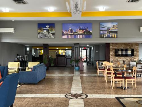 a lobby of a hotel with tables and chairs at Quality Inn & Suites Chattanooga-East Ridge in Chattanooga