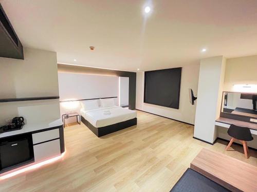 a bedroom with a bed and a flat screen tv at 9D City & 9D Express Hotel in Udon Thani