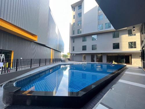 a swimming pool in the middle of a building at 9D City & 9D Express Hotel in Udon Thani