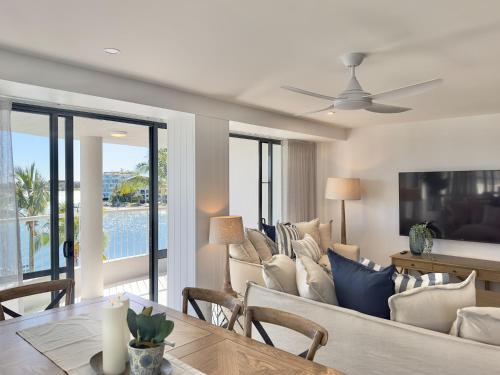 a living room with a couch and a table at Noosa Pacific Resort in Noosaville