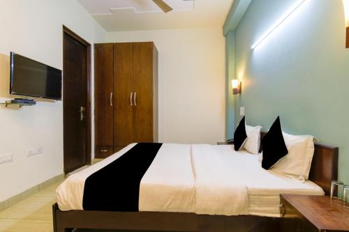 a bedroom with a large bed and a tv at Hotel Royal Red Rohini Sector 23 in New Delhi