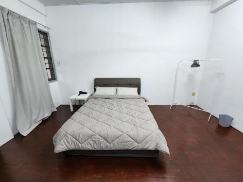 a bedroom with a bed and a wooden floor at DE ELITE KUCHING HOMESTAY in Kuching