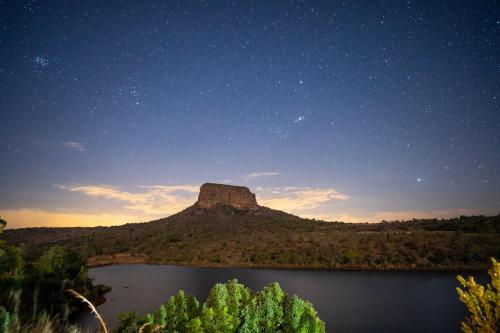 a view of a mountain under a starry sky at Entabeni Mountain Lodges in Golders Green