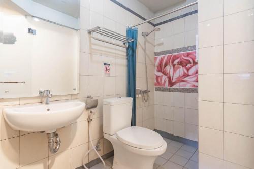 a bathroom with a toilet and a sink at RedDoorz Plus near Asia Afrika 3 in Bandung