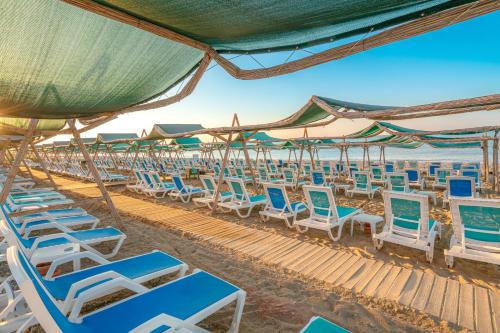 a group of chairs and umbrellas on the beach at SUN HEAVEN FAMILY & SPA in Alanya