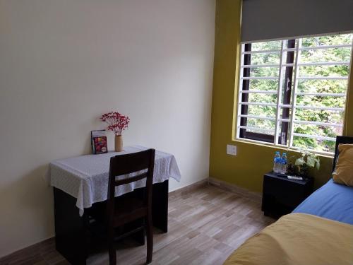 a dining room with a table and a window at Giao Hòa Homestay Hội An in Hoi An