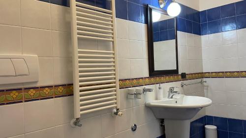 a bathroom with a sink and a mirror at La Contessa B&B Palazzo Plantulli in Avellino