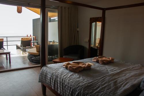 a bedroom with a bed with two towels on it at COCO CABANA in Palolem