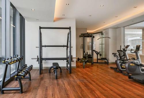 a gym with several treadmills and exercise equipment at Movenpick Living Istanbul West in Istanbul