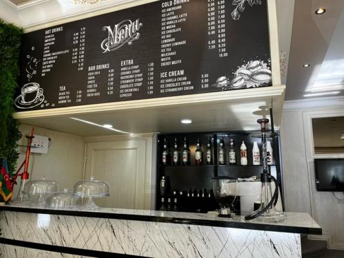 a menu on the wall of a restaurant with wine bottles at Karat Inn Boutique Hotel in Baku