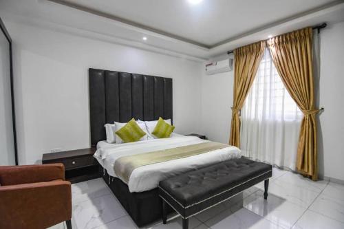 a bedroom with a large bed with a black headboard at Luxury 1 bedroom apartment in the heart of lekki in Lekki