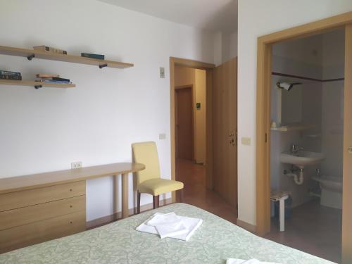 a room with a bed and a desk and a sink at Da Teresa in Bardineto
