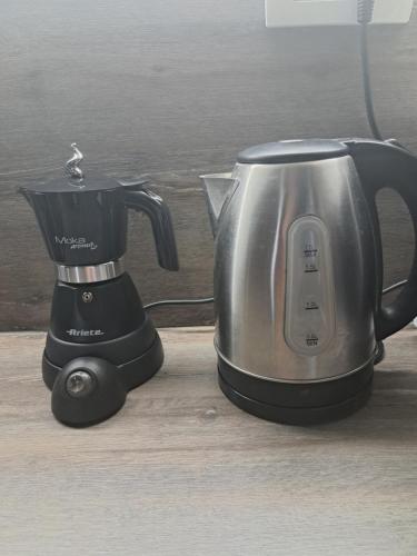 a kettle and a blender sitting on a table at Aparthouse Alfa1 in Čatež ob Savi