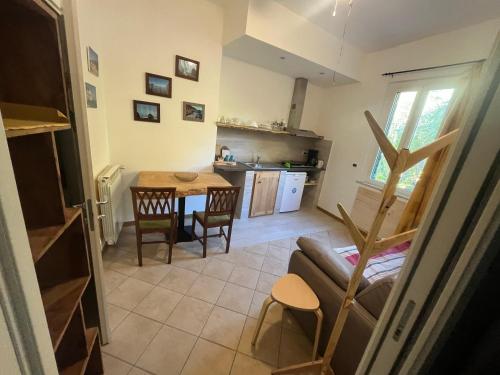 a living room with a table and a kitchen at Ai Cinque Campanili in Finale Ligure