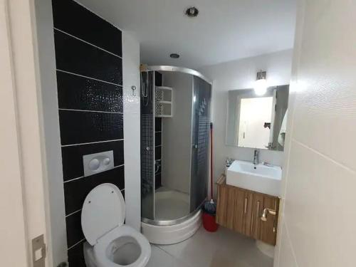 a bathroom with a toilet and a shower and a sink at Marina Residence in Antalya