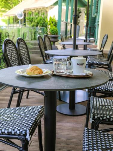 a table with a cup of coffee and a plate of food at Spa Suite Dobrna - Terme Dobrna in Dobrna
