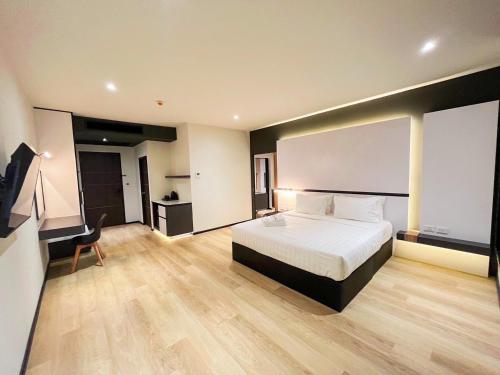 a hotel room with a bed and a television at 9D City & 9D Express Hotel in Udon Thani