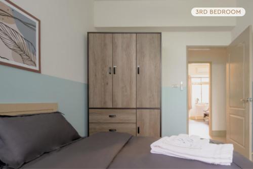 Ένα ή περισσότερα κρεβάτια σε δωμάτιο στο Perfect Family Home 3B2b Taipei 101 & MRT-4 min 完美家庭住宅 3房2衛 4分到台北101