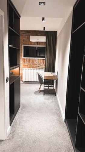 a living room with a table and a chair at Nani Nani Boutique in Braşov