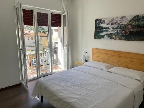 a bedroom with a large bed and a large window at Nest & Relax in Trento