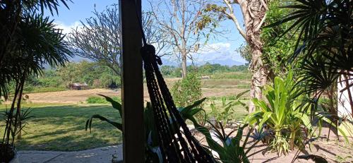 a view from the window of a room with a hammock at Kuad Khon Thoe Pai Cottage in Pai