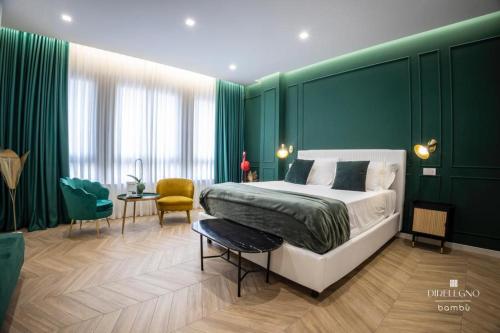 a bedroom with a bed and a green wall at Salotto Room Boutique Pescara in Pescara