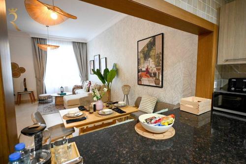 a living room with a table and a living room with a couch at Modern 1BR Stay - Yas Natura Chic Luxe Retreat in Abu Dhabi