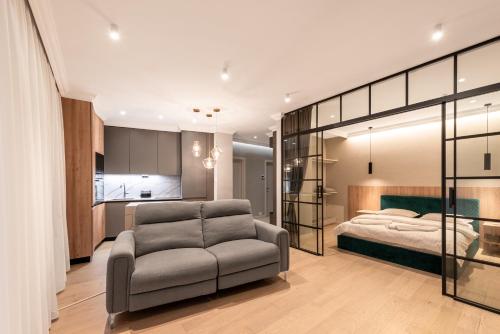 a bedroom with a couch and a bed in it at Urban Studio @ Record Park in Cluj-Napoca