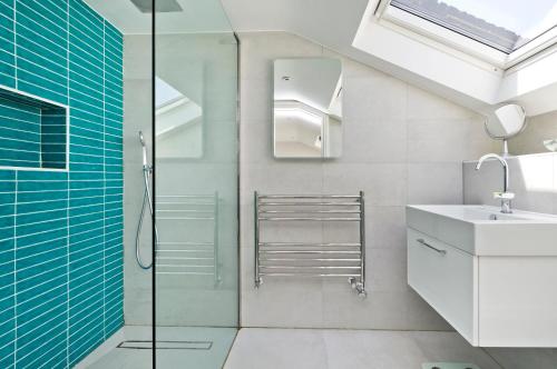 a bathroom with a shower and a sink at Veeve - Open Skies in London