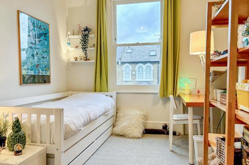 a small bedroom with a bed and a window at Veeve - Open Skies in London
