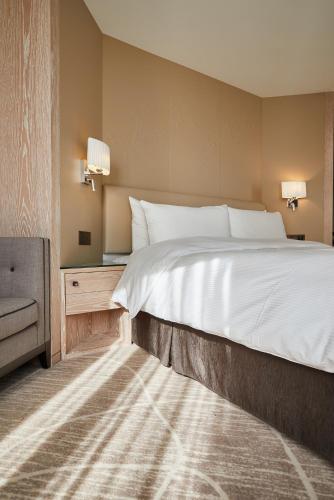 a bedroom with a large bed and a television at K Hotel Taipei Chang-An in Taipei