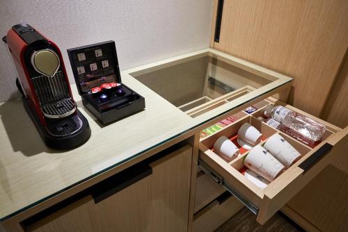 a room with a counter with a phone on it at K Hotel Taipei Chang-An in Taipei