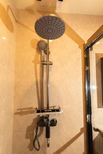 a shower in a bathroom with a shower head at Johannes Condo in Baguio Megatower IV in Baguio
