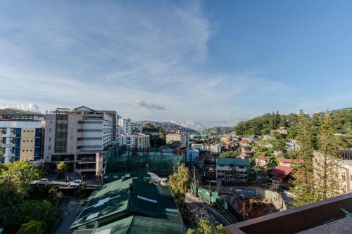 a city with buildings and mountains in the background at Johannes Condo in Baguio Megatower IV in Baguio